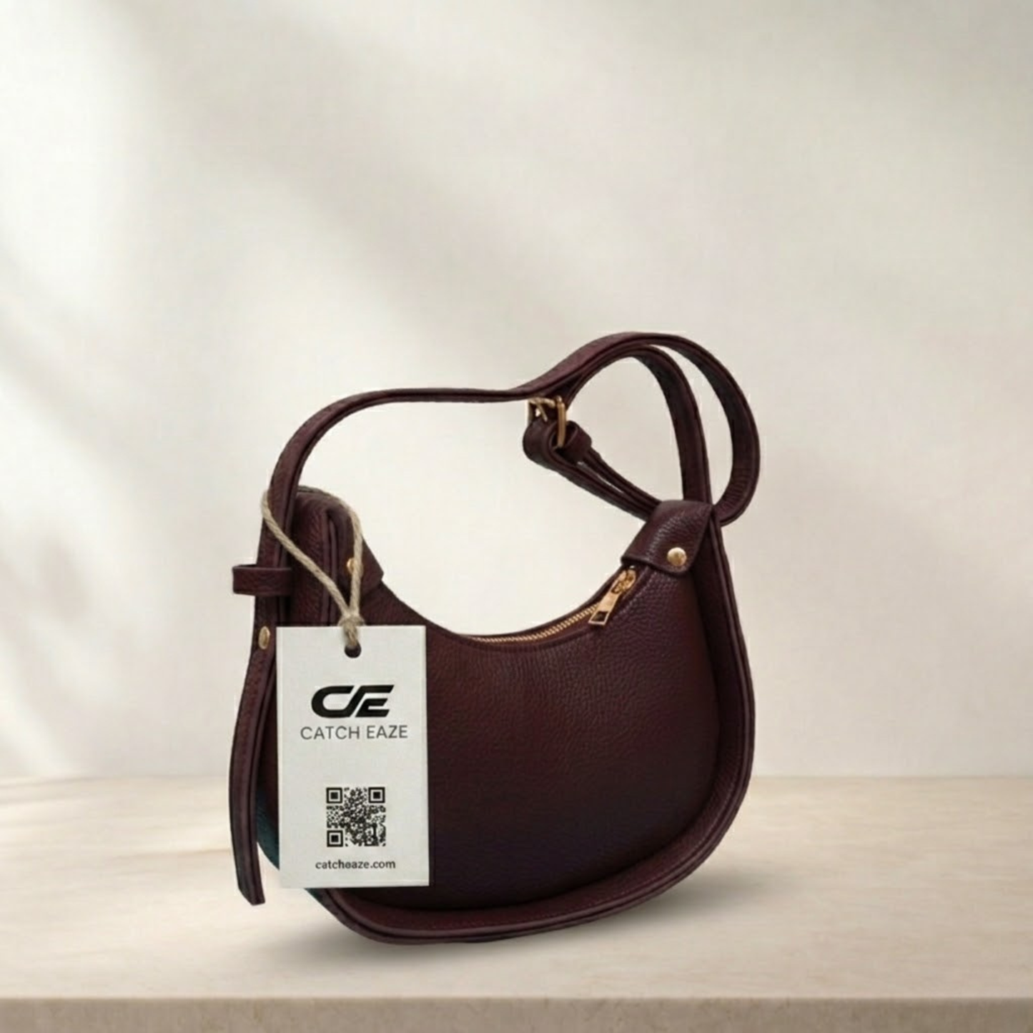 Brown handbag with a visible brand tag on a light background