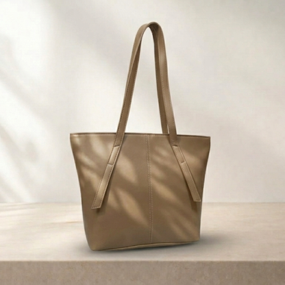 Beige tote bag on a light wooden surface with a neutral background