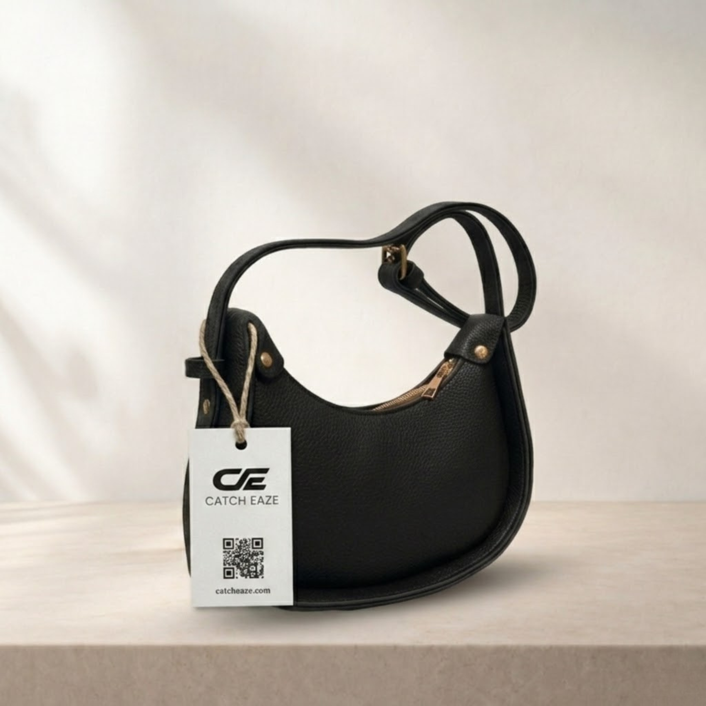 Black handbag with a visible brand tag on a neutral background