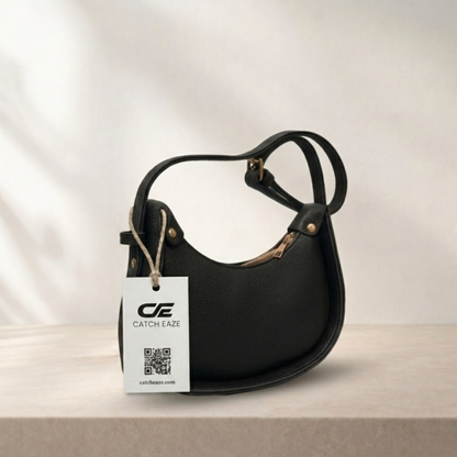 Black handbag with a visible brand tag on a neutral background