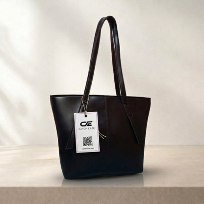 Black handbag with a visible brand tag on a neutral background