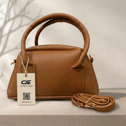 Brown handbag with matching strap and Catch Eaze tag on a neutral background