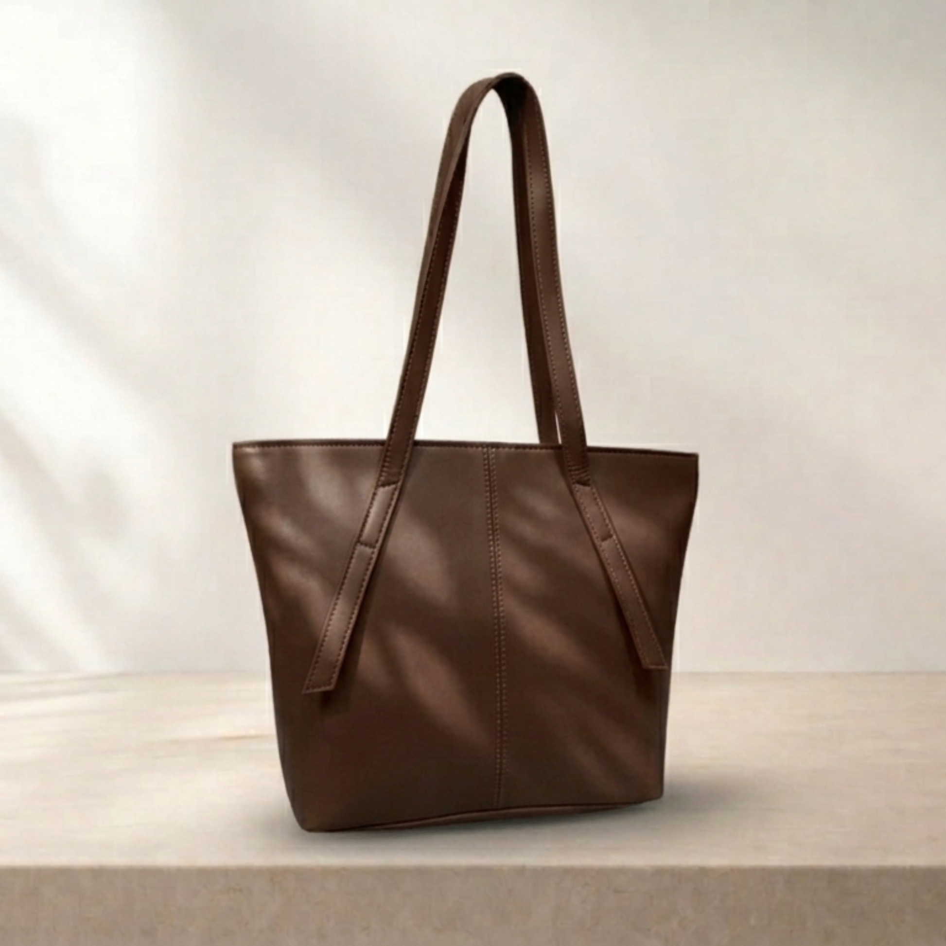 Brown leather tote bag on a light background
