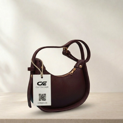 Brown handbag with a visible brand tag on a light background
