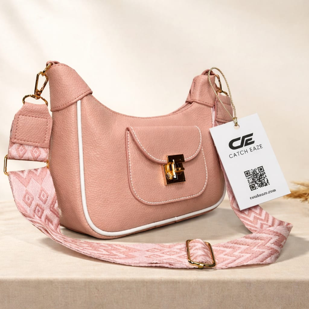 Pink handbag with a matching strap on a beige background, featuring a brand tag.