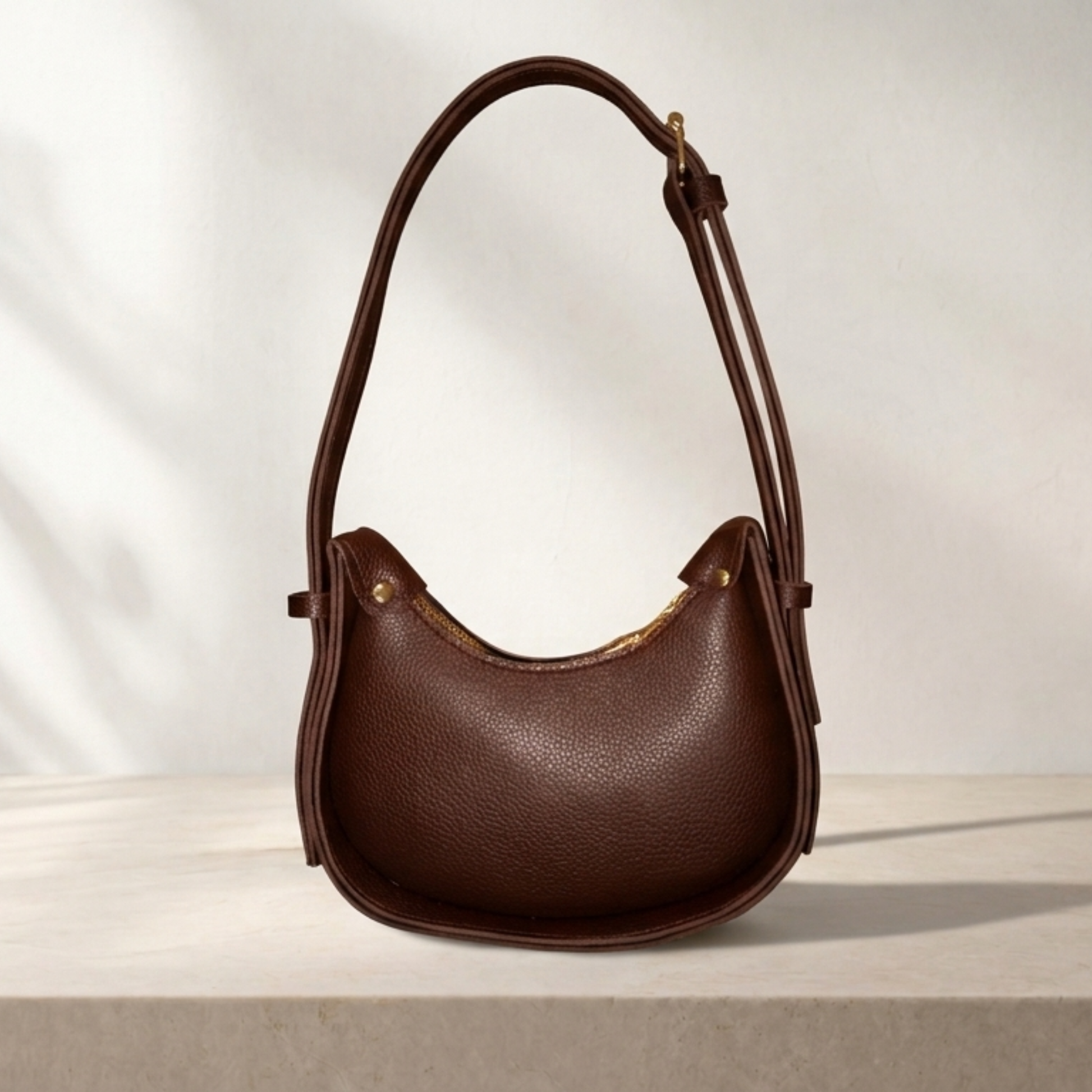 Brown leather handbag on a light background