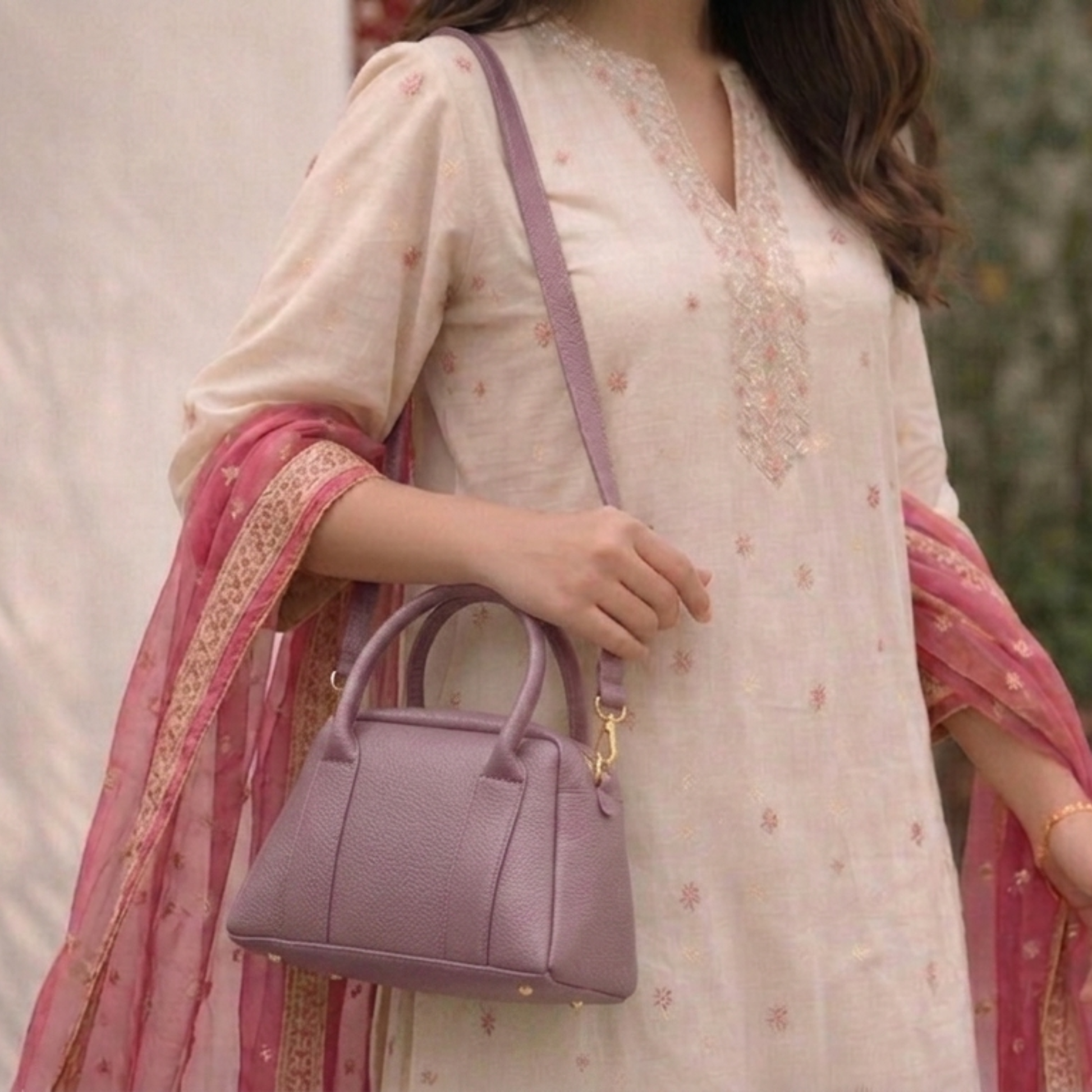 Woman holding a purple handbag with a blurred background