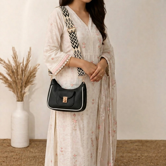 Woman holding a black handbag with a white background